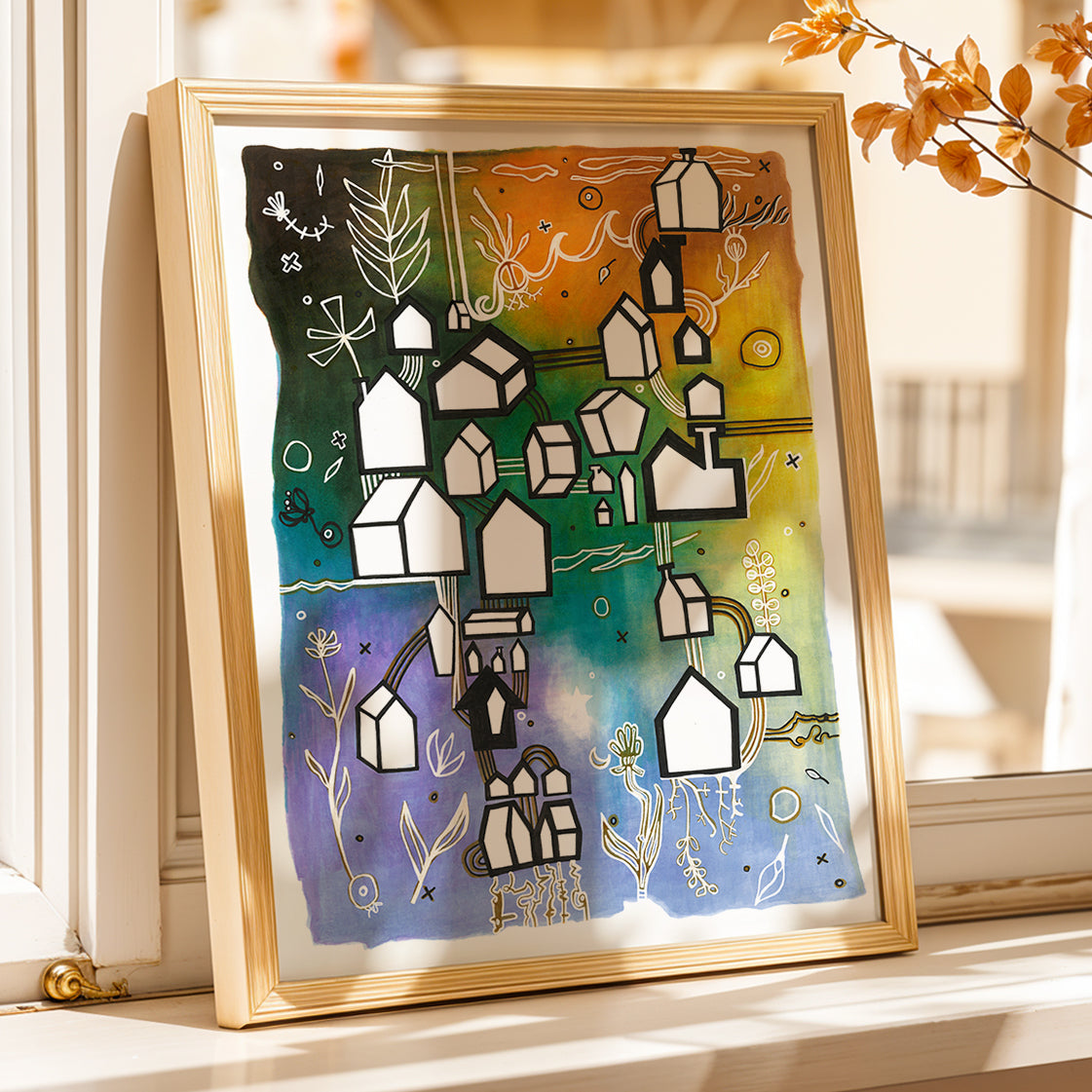 Framed Home village houses print by Joy and Fury Art on a sunny windowsill