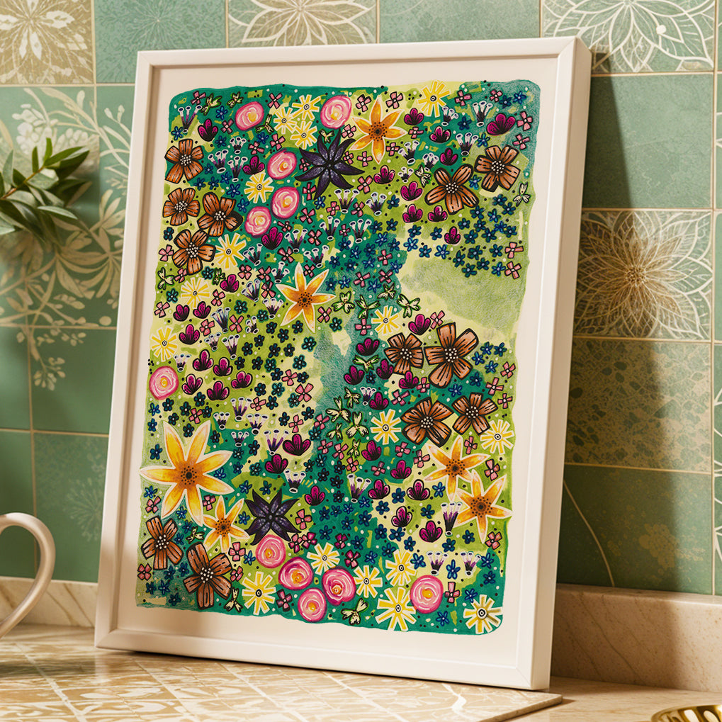 Framed colorful floral Bloom print by Joy and Fury Art against a tiled wall