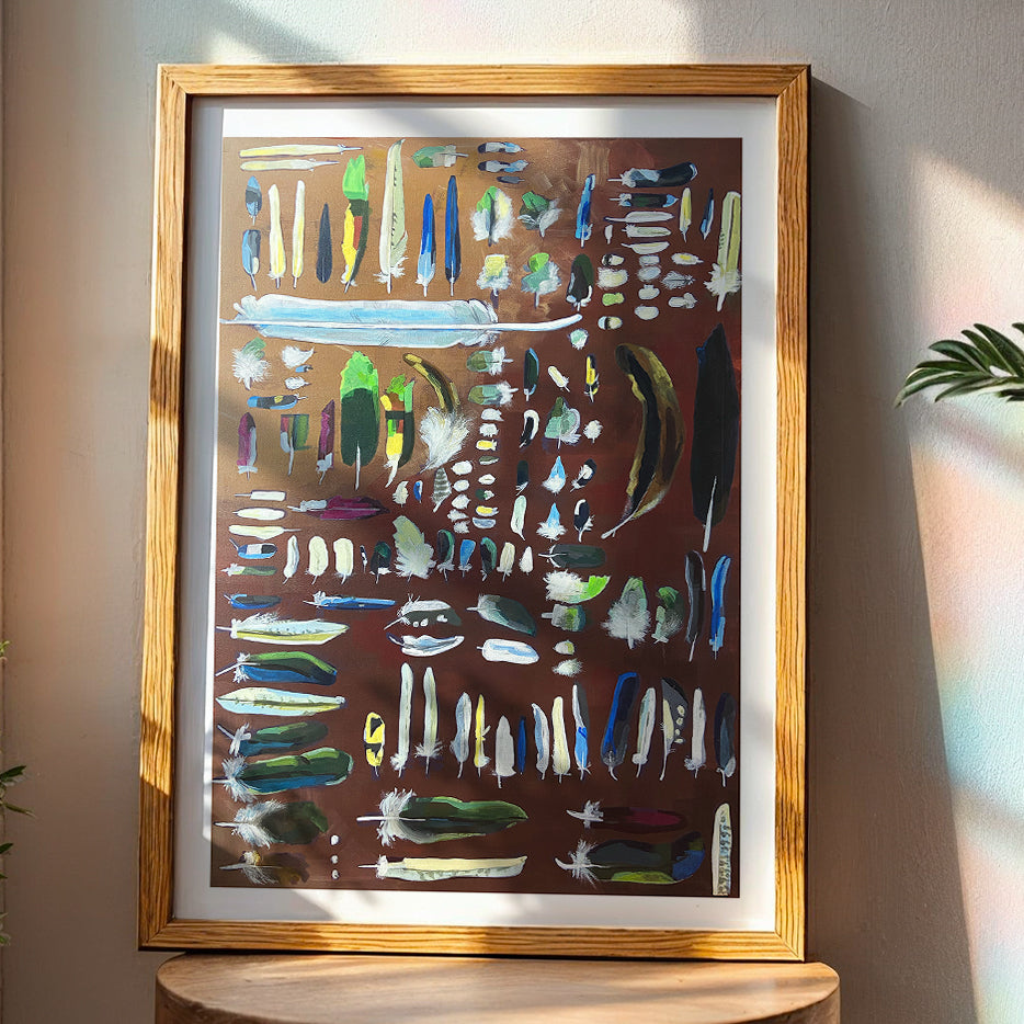 Framed colorful feathers print by Joy and Fury Art on a wooden stool